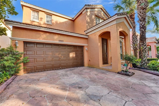 mediterranean / spanish-style home featuring a garage