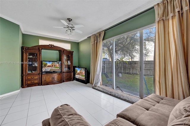 tiled living room with ceiling fan and crown molding