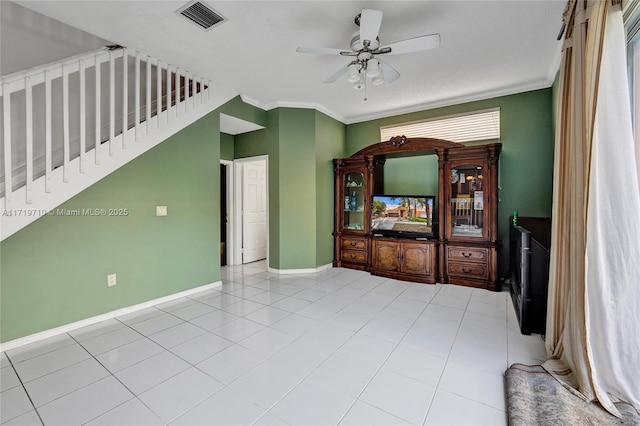 unfurnished living room featuring ceiling fan, light tile patterned flooring, and ornamental molding