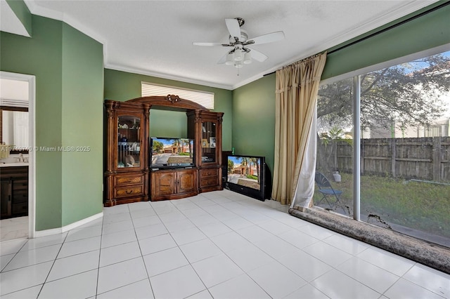 unfurnished living room featuring ceiling fan, sink, light tile patterned floors, and ornamental molding