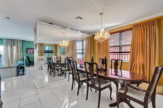 dining area with light tile patterned floors, a textured ceiling, crown molding, and a notable chandelier