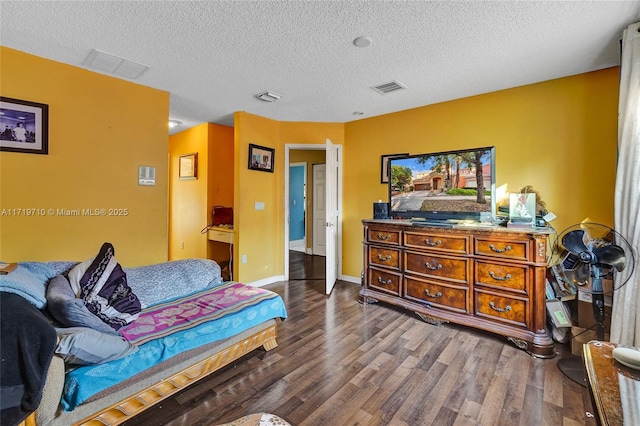 bedroom with wood-type flooring and a textured ceiling