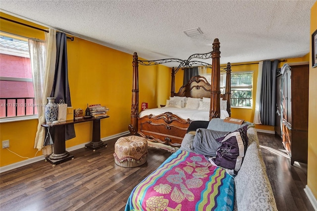 bedroom featuring a textured ceiling and dark wood-type flooring