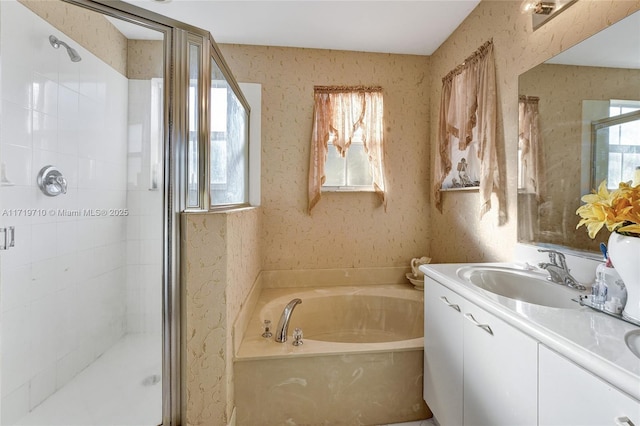 bathroom featuring vanity, separate shower and tub, and a healthy amount of sunlight