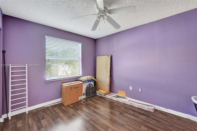 empty room featuring a textured ceiling, ceiling fan, and dark hardwood / wood-style floors