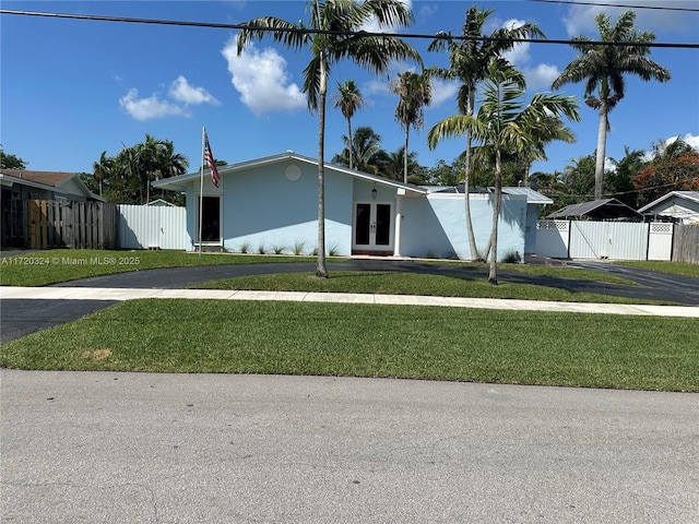 9920 SW 194th St, Cutler Bay, FL 33157 - view of front facade with french doors, driveway, a gate, and stucco siding