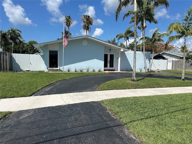 9920 SW 194th St, Cutler Bay, FL 33157 - view of front facade featuring french doors, driveway, a gate, and stucco siding