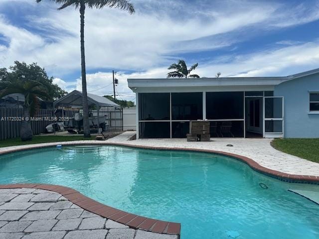 view of pool featuring a patio and a sunroom