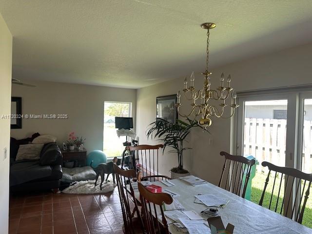 tiled dining area with a notable chandelier