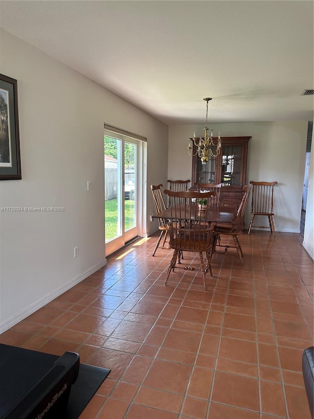 9920 SW 194th St, Cutler Bay, FL 33157 - dining area featuring a chandelier, baseboards, and tile patterned floors