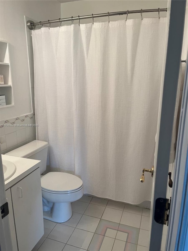 9920 SW 194th St, Cutler Bay, FL 33157 - bathroom with vanity, toilet, tile patterned floors, tile walls, and a shower with curtain