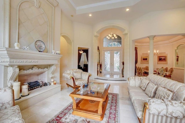 6139 Via Venetia S, Delray Beach, FL 33484 - living room featuring a chandelier, recessed lighting, french doors, ornamental molding, and arched walkways