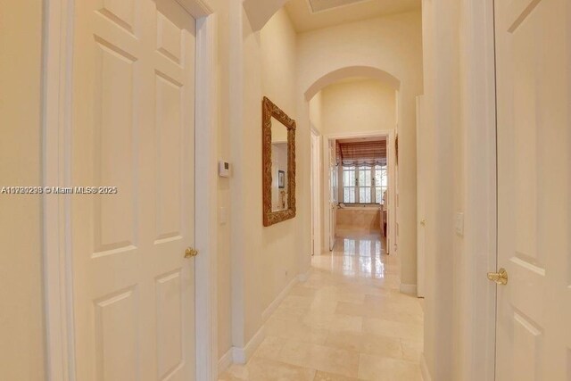 6139 Via Venetia S, Delray Beach, FL 33484 - hall featuring arched walkways and baseboards