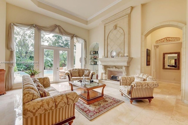 6139 Via Venetia S, Delray Beach, FL 33484 - living room with ornamental molding, french doors, a high ceiling, and a premium fireplace