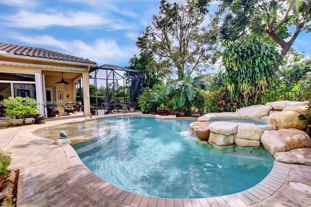 6139 Via Venetia S, Delray Beach, FL 33484 - swimming pool featuring ceiling fan, a patio, and glass enclosure