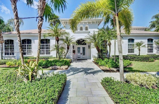 6139 Via Venetia S, Delray Beach, FL 33484 - mediterranean / spanish-style house featuring french doors, stucco siding, and a tile roof