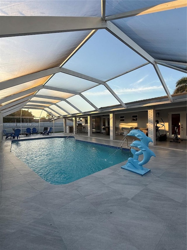 view of swimming pool with a patio and a lanai