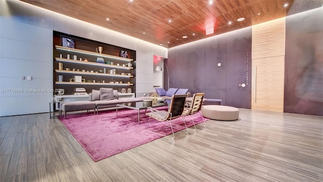 cinema room with hardwood / wood-style floors, built in features, and wooden ceiling