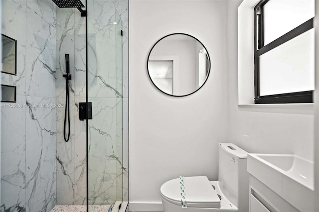 bathroom featuring vanity, toilet, and tiled shower