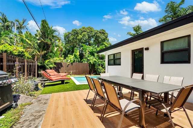 wooden deck featuring a fenced in pool