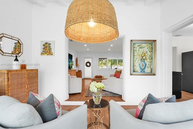 living room with beamed ceiling and light wood-type flooring