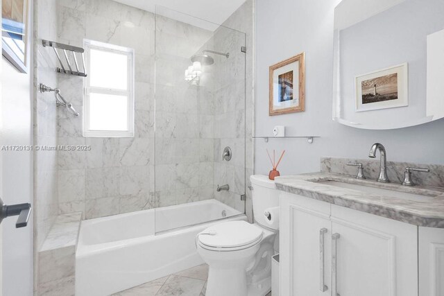 full bathroom with vanity, toilet, and tiled shower / bath