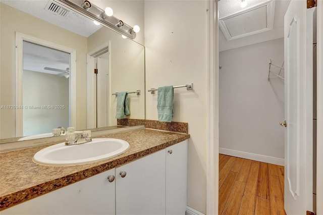 bathroom with ceiling fan, wood-type flooring, and vanity