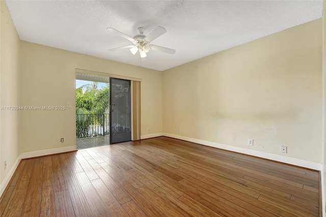 empty room featuring hardwood / wood-style flooring, ceiling fan, and a textured ceiling