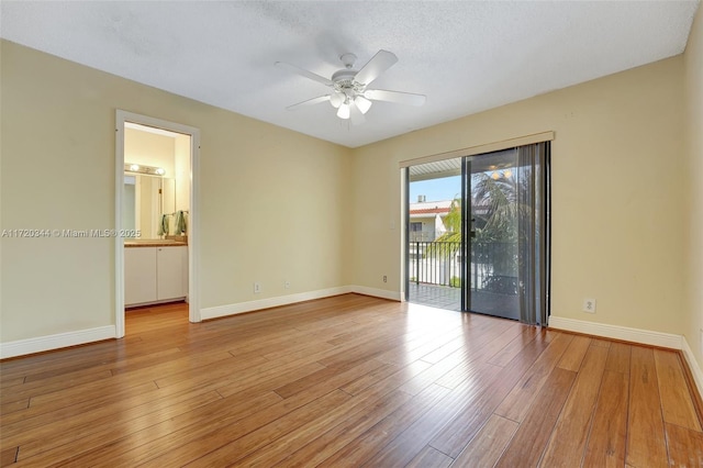 empty room featuring ceiling fan, light hardwood / wood-style floors, and a textured ceiling