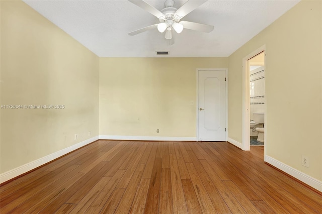 spare room featuring hardwood / wood-style floors and ceiling fan