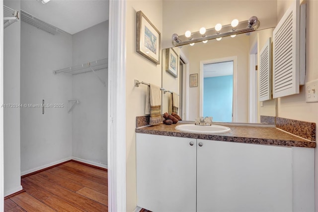 bathroom with hardwood / wood-style floors and vanity