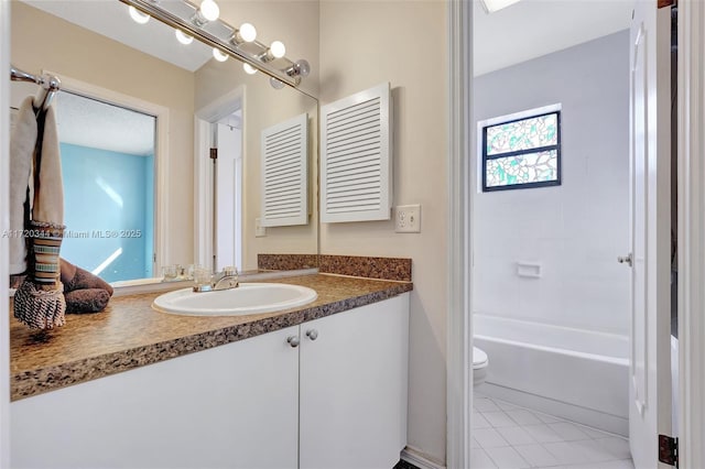 full bathroom featuring tile patterned floors, vanity, bathtub / shower combination, and toilet