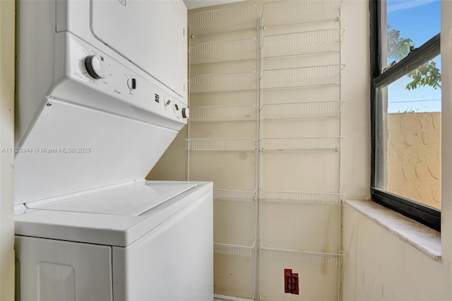 laundry area featuring stacked washer / dryer