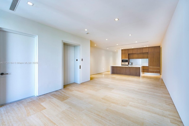 unfurnished living room with sink and elevator