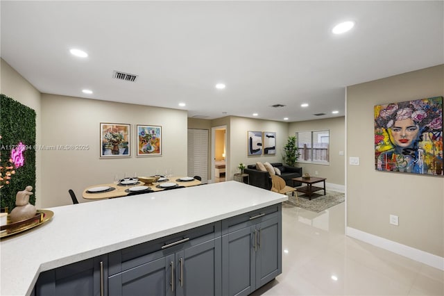 kitchen with light tile patterned floors and gray cabinetry