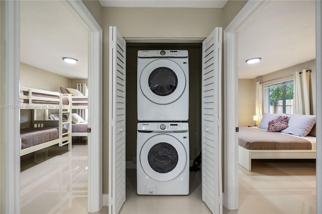 washroom featuring stacked washer / dryer