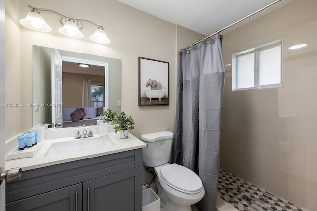 bathroom with vanity, toilet, and curtained shower