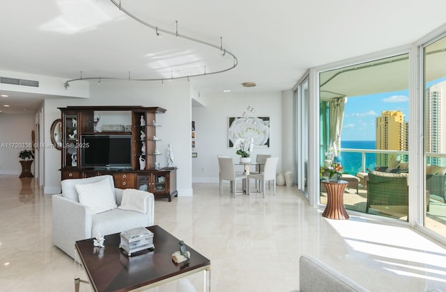 living room with a wall of windows and a wealth of natural light