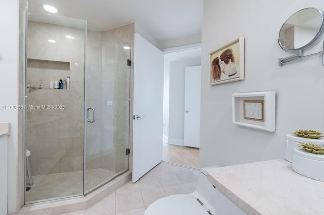 bathroom with tile patterned floors, vanity, and an enclosed shower