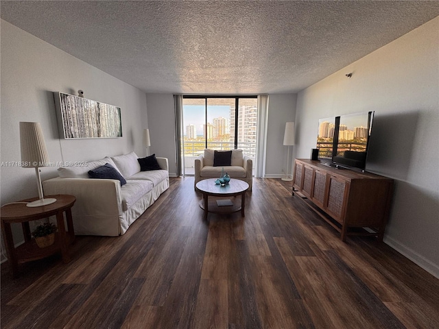 living room with a textured ceiling, floor to ceiling windows, and dark wood-type flooring