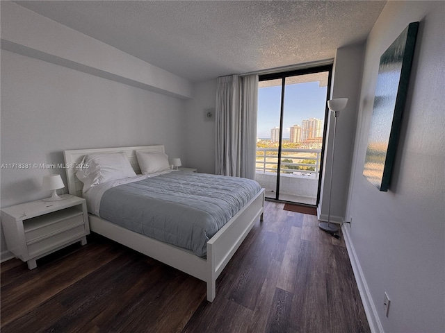 bedroom with floor to ceiling windows, dark hardwood / wood-style flooring, access to outside, and multiple windows