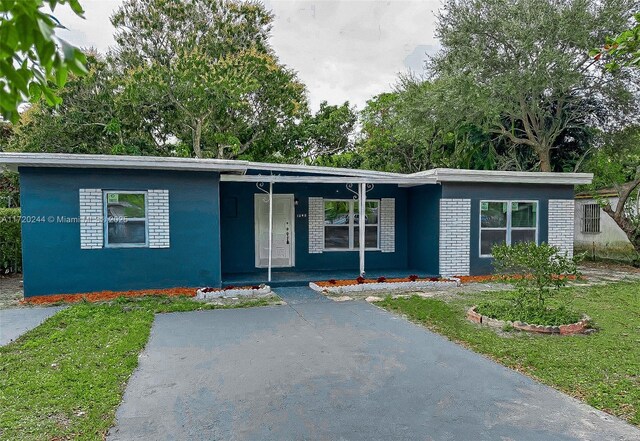 single story home with a front lawn and a porch