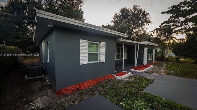 property exterior at dusk featuring central AC