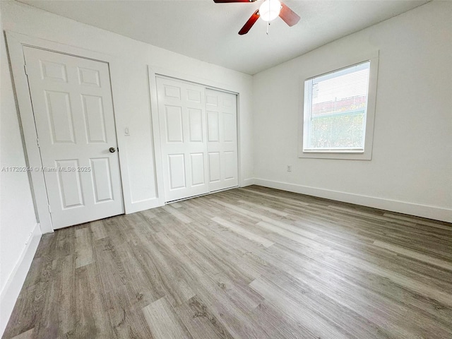 unfurnished bedroom featuring ceiling fan and light hardwood / wood-style floors