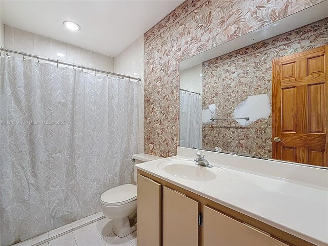 bathroom with vanity, tile patterned floors, and toilet