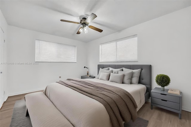 bedroom with hardwood / wood-style flooring and ceiling fan