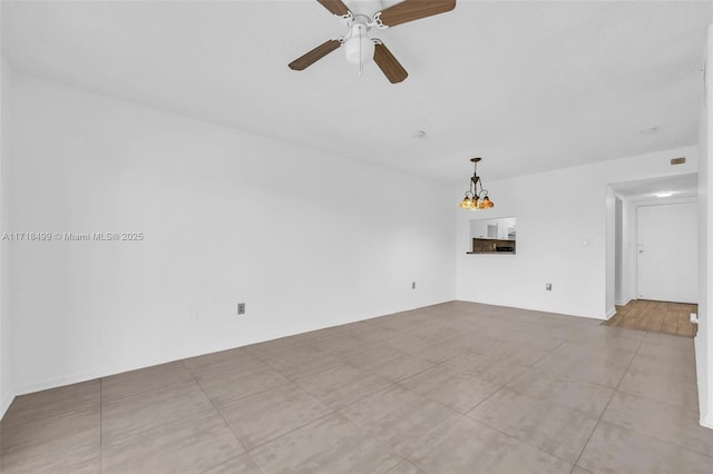 unfurnished living room featuring light tile patterned floors and ceiling fan with notable chandelier