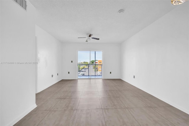 spare room with a textured ceiling and ceiling fan