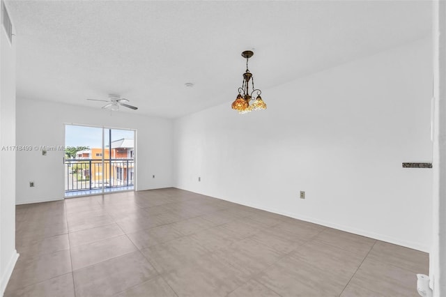 unfurnished room featuring ceiling fan with notable chandelier and light tile patterned flooring