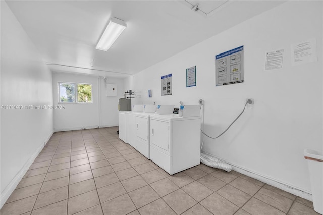 laundry room featuring independent washer and dryer and light tile patterned floors